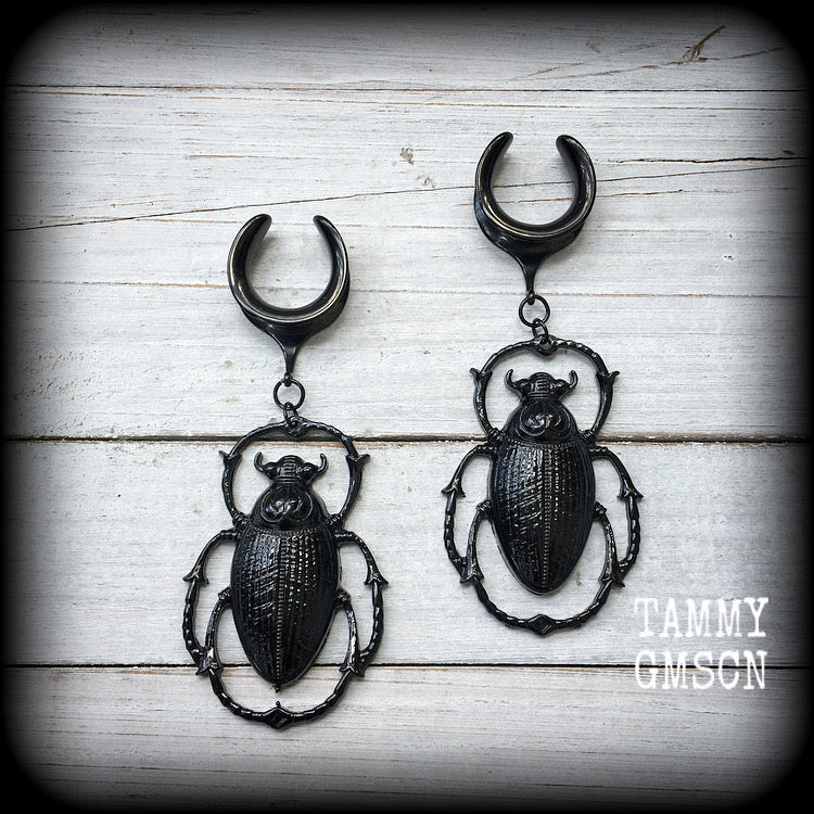 These gorgeous black enamel 'Scarab beetle' gauged earrings measure approx 9cms from tip to tip, and weigh approx. 16 grams a piece, not too heavy.
This pair has been made on 3/4" gauge (19mm) gauge surgical steel cradles, to be worn in stretched lobes.