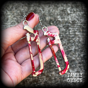 Bone saw earrings Hack saw earrings Halloween earrings Murder weapon True crime earrings Blood spatter Horrorpunk earrings Haooror punk jewelry Horror movies Slasher movies Pierced ears Ear gauges Mortuary equipment Medical instruments Zombie earring