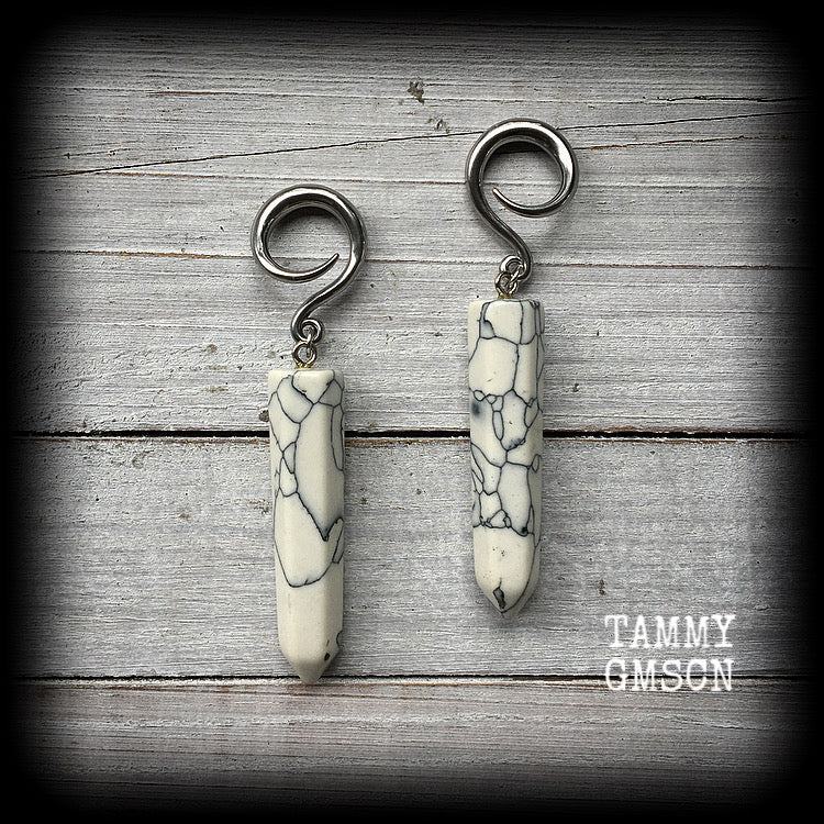 These earrings are made with beautiful white howlite stone points, measuring just on 8cms from tip to tip, and weighing approx 13grams each.
This pair has been made on 6 gauge (4mm) surgical steel full curl hooks, to be worn in stretched lobes.