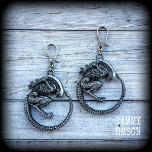 These awesome earrings feature a pair of large pewter Alien Queen Xenomorphs, measuring 9cms from tip to tip (nice and big), and weigh 38 grams each (these are HEAVY).

This pair have been made on small antique silver shephard hooks to be worn in stretched lobes with silicone earlets from 8 gauge (3mm).