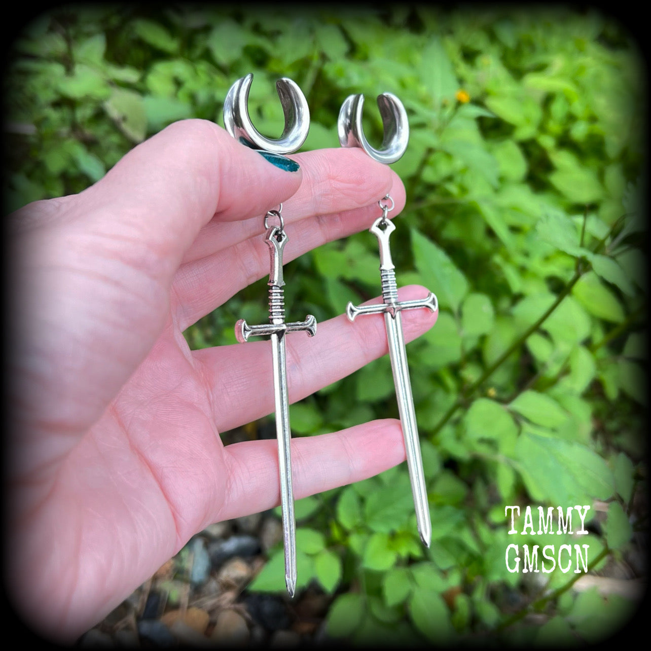 Our 'Ace of Swords' ear hangers feature a gorgeous long antique silver sword pendant, measuring just over 12cms from tip to tip, and weighing approx 9 grams each.

This pair has been made on 9/16" (14mm) surgical steel cradles, to be worn in stretched lobes.