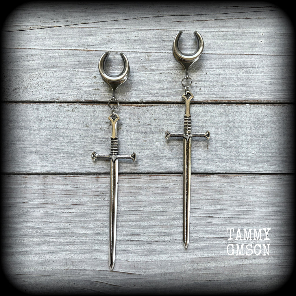 Our 'Ace of Swords' ear hangers feature a gorgeous long antique silver sword pendant, measuring just over 12cms from tip to tip, and weighing approx 9 grams each.

This pair has been made on 9/16" (14mm) surgical steel cradles, to be worn in stretched lobes.