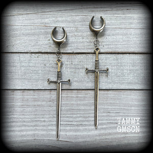 Our 'Ace of Swords' ear hangers feature a gorgeous long antique silver sword pendant, measuring just over 12cms from tip to tip, and weighing approx 9 grams each.

This pair has been made on 9/16" (14mm) surgical steel cradles, to be worn in stretched lobes.