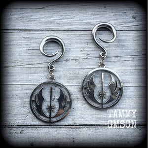 Featuring the symbol of the Jedi Order, these earrings are nice and lightweight at only 9 grams a piece, and measure just over 6cms from tip to tip, a must have for any Star Wars fan!

This pair has been made on 6 gauge (4mm) surgical steel full curls, to be worn in stretched lobes.