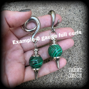 These gorgeous earrings feature deep green Malachite pendulums, weighing in at approx 26 grams each, and measure just on 8 cms from tip to tip, nice and dangly.

This pair has been made with 0 gauge (8mm) surgical steel full curl hooks, suitable for stretched lobes. 