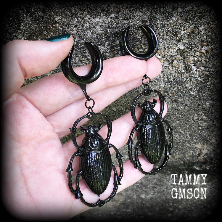 These gorgeous black enamel 'Scarab beetle' gauged earrings measure approx 9cms from tip to tip, and weigh approx. 16 grams a piece, not too heavy.
This pair has been made on 3/4" gauge (19mm) gauge surgical steel cradles, to be worn in stretched lobes.