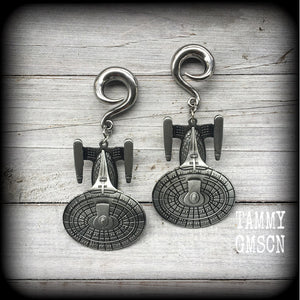 These gorgeous gauged earrings feature the Star Trek USS Enterprise, measuring just on 10cms from tip to tip and weighing approx 45 grams a piece, these earrings are BIG, DANGLY and HEAVY.

This pair has been made on 0 gauge (8mm) surgical steel full curl hooks, to be worn in stretched lobes.
