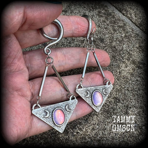 Featuring an inverted triangle with crescent moons and a single translucent purple cabachon, measuring just over 7 cms from tip to tip, and weighing approx 8 grams each.
This pair has been made on 6 gauge (4mm) surgical steel full curl hooks.