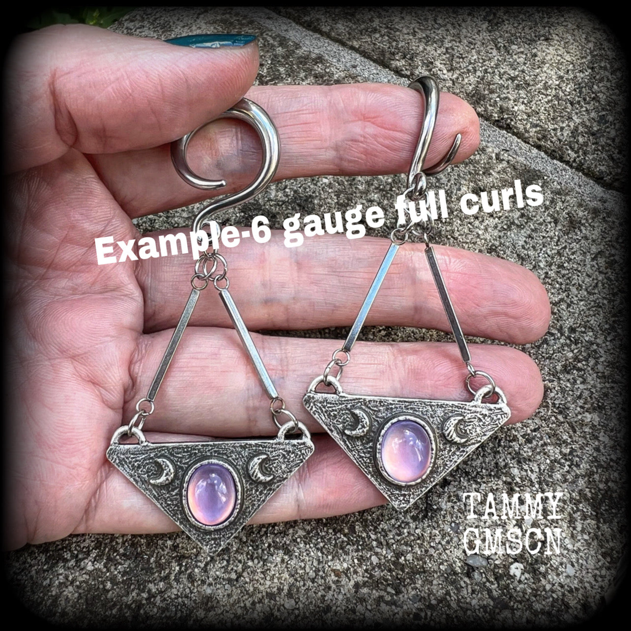 Featuring an inverted triangle with crescent moons and a single translucent purple cabachon, measuring just over 7 cms from tip to tip, and weighing approx 8 grams each.
This pair has been made on 6 gauge (4mm) surgical steel full curl hooks.