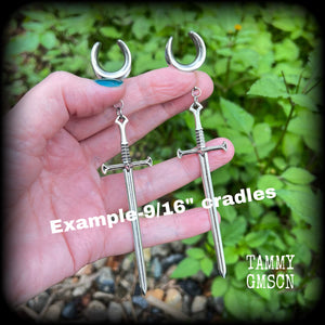 Our 'Ace of Swords' ear hangers feature a gorgeous long antique silver sword pendant, measuring just over 12cms from tip to tip, and weighing approx 9 grams each.

This pair has been made on 9/16" (14mm) surgical steel cradles, to be worn in stretched lobes.