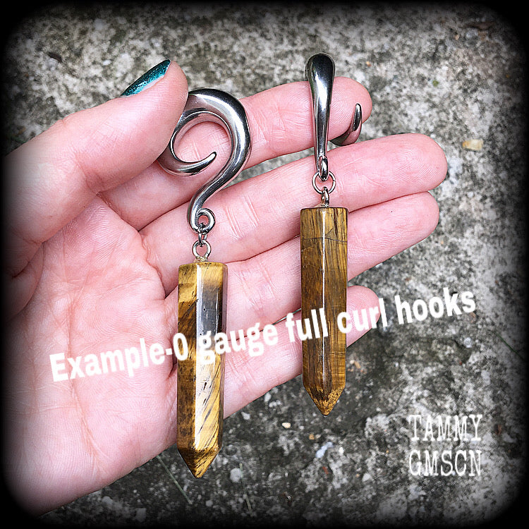 These gauged earrings are made with gorgeous Tigers eye points, measuring just over 9cms from tip to tip, and weighing approx 25grams each.
This pair have been made on 0 gauge (8mm) surgical steel full curl hooks, to be worn in stretched lobes.