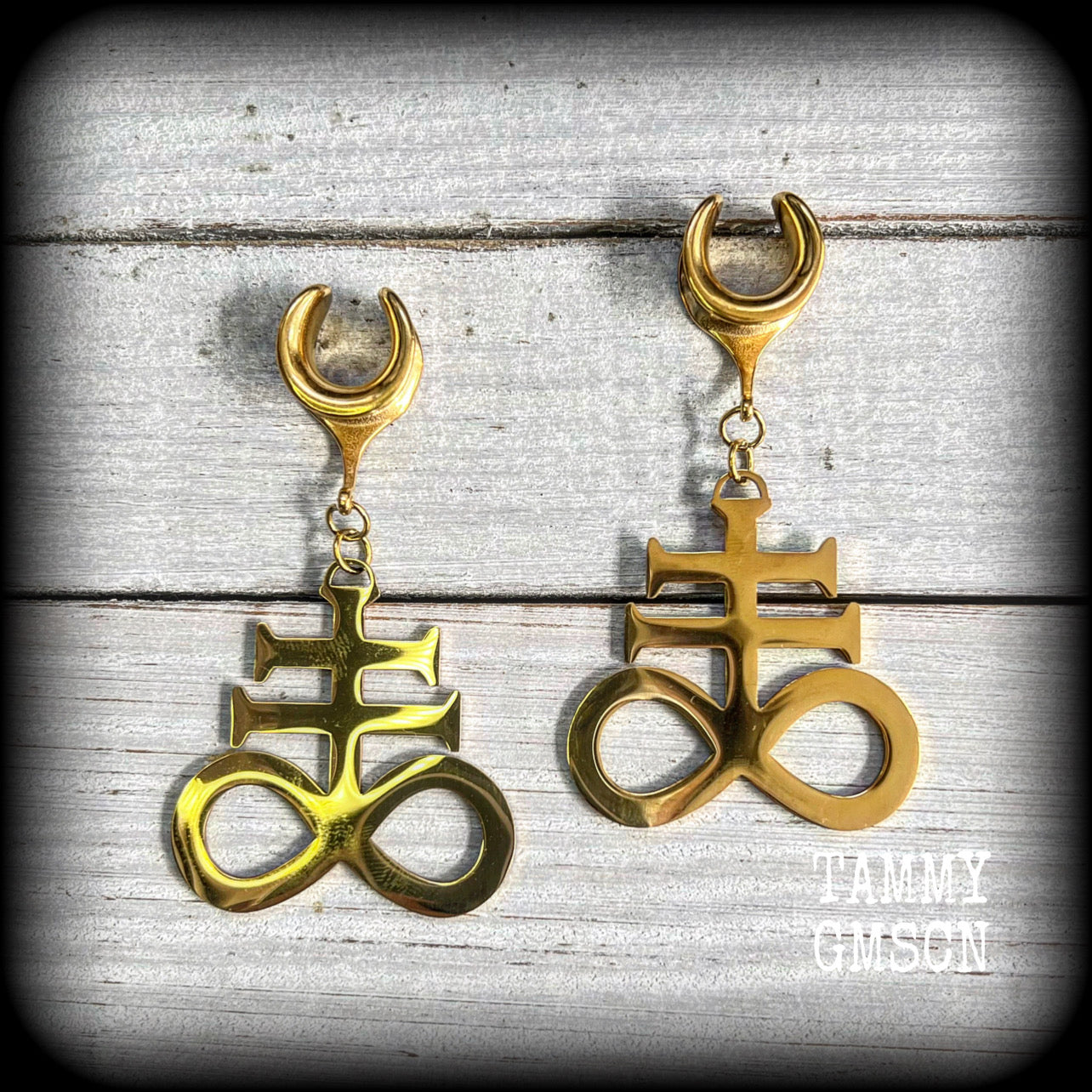 These gorgeous gold titanium earrings feature large Sigil of sulphur brimstone charms, weighing approx 8 grams each, and measuring around 7 cms from tip to tip.
This pair has been made on 1/2" gauge (12mm) surgical steel cradles, to be worn in stretched lobes.