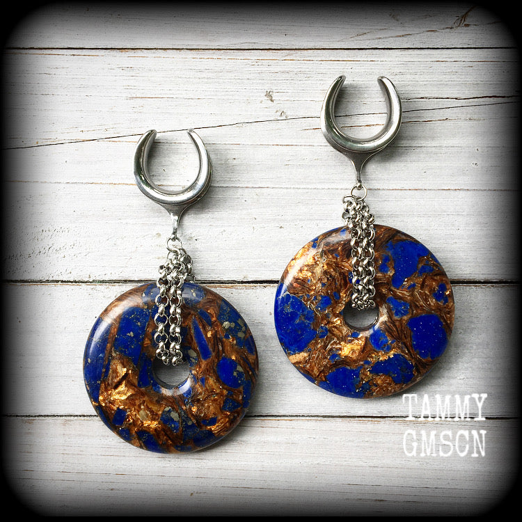 Featuring a pair of gorgeous dark blue lapis lazuli and bronzite donut gemstones cradles in stainless steel chain, this pair of ear hangers weigh approx 34 grams a piece, and measure just under 10cms from tip to tip.

This pair have been made on 7/8" (22mm) gauge surgical steel cradles, for stretched lobes.