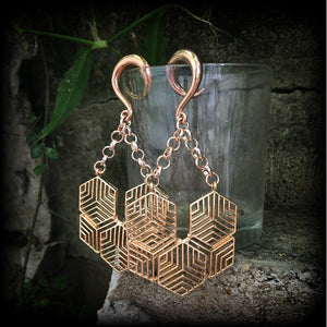 These gauged earrings feature beautiful rose gold tone geometric hexagon pendants, measuring just over 10cms from tip to tip, and weighing approx 22 grams each.
This pair has been made on 2 gauge (6mm) surgical steel full curl hooks.