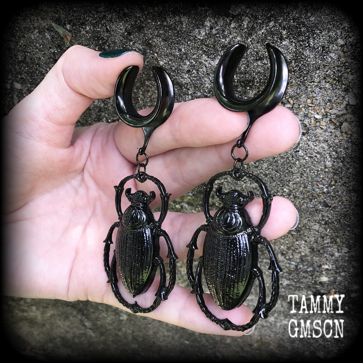 These gorgeous black enamel 'Scarab beetle' gauged earrings measure approx 9cms from tip to tip, and weigh approx. 16 grams a piece, not too heavy.
This pair has been made on 3/4" gauge (19mm) gauge surgical steel cradles, to be worn in stretched lobes.