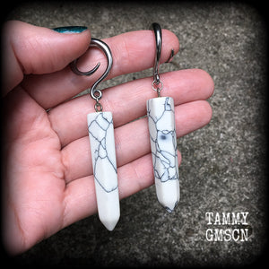 These earrings are made with beautiful white howlite stone points, measuring just on 8cms from tip to tip, and weighing approx 13grams each.
This pair has been made on 6 gauge (4mm) surgical steel full curl hooks, to be worn in stretched lobes.