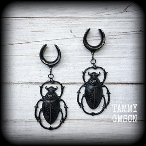 These gorgeous black enamel 'Scarab beetle' gauged earrings measure approx 9cms from tip to tip, and weigh approx. 16 grams a piece, not too heavy.
This pair has been made on 3/4" gauge (19mm) gauge surgical steel cradles, to be worn in stretched lobes.