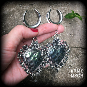 These gorgeous antique silver gauged earrings feature big beautiful sacred hearts, measuring 11cms from tip to tip, and weighing approx 21 grams each.

This pair has been made on 1" gauge (25mm) surgical steel cradles, to be worn in stretched lobes.