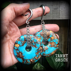 These earrings feature sky blue turquoise and bronzite gemstones cradled in antique silver chain. This pair weighs approx 32 grams a piece, and measure 10cms from tip to tip.
These have been made on 6 gauge (4mm) surgical steel full curl hooks.