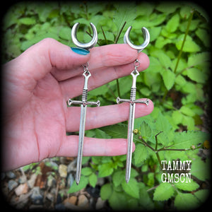 Our 'Ace of Swords' ear hangers feature a gorgeous long antique silver sword pendant, measuring just over 12cms from tip to tip, and weighing approx 9 grams each.

This pair has been made on 9/16" (14mm) surgical steel cradles, to be worn in stretched lobes.