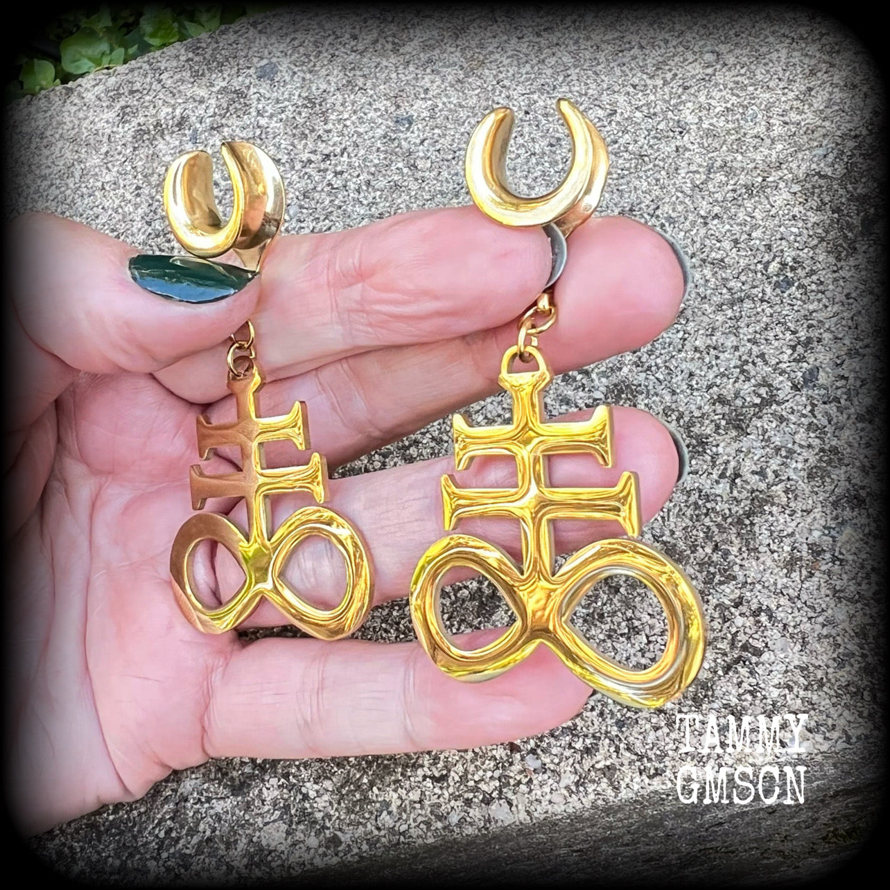 These gorgeous gold titanium earrings feature large Sigil of sulphur brimstone charms, weighing approx 8 grams each, and measuring around 7 cms from tip to tip.
This pair has been made on 1/2" gauge (12mm) surgical steel cradles, to be worn in stretched lobes.