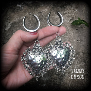 These gorgeous antique silver gauged earrings feature big beautiful sacred hearts, measuring 11cms from tip to tip, and weighing approx 21 grams each.

This pair has been made on 1" gauge (25mm) surgical steel cradles, to be worn in stretched lobes.