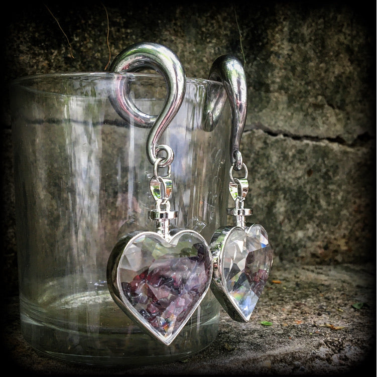 Heart shaped glass bottles filled with garnet gemstone chips, available on a range of hooks and clasps for pierced ears and stretched lobes.