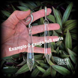 These gorgeous dangly glass earrings have been made with gorgeous faceted clear glass spears, measuring 13 cms from tip to tip, and weighing approx 13 grams each.

These earrings have been made on 3/4" gauge (19mm) surgical steel cradles, to be worn in stretched lobes.