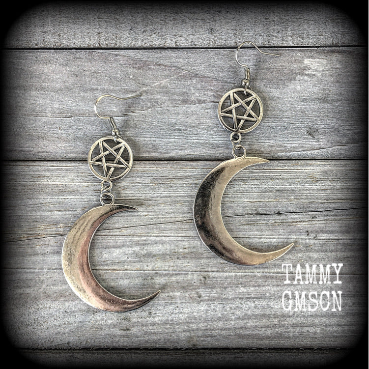 Featuring large antique silver crescent moons hanging from antique silver inverted pentagram charms, these gorgeous gothic earrings measure just on 10cms from tip to tip and weigh approx 6cm each.

This pair has been made with stainless steel french hooks, for pierced ears.