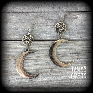 Featuring large antique silver crescent moons hanging from antique silver inverted pentagram charms, these gorgeous gothic earrings measure just on 10cms from tip to tip and weigh approx 6cm each.

This pair has been made with stainless steel french hooks, for pierced ears.