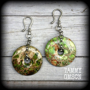 Featuring lime green ocean jasper donut gemstones, these earrings weigh in at approx 35 grams a piece, and hang just on 10cms from tip to tip.
This pair has been made with large antique silver shephard hooks, for stretched ears.