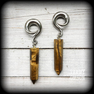 These gauged earrings are made with gorgeous Tigers eye points, measuring just over 9cms from tip to tip, and weighing approx 25grams each.
This pair have been made on 0 gauge (8mm) surgical steel full curl hooks, to be worn in stretched lobes.