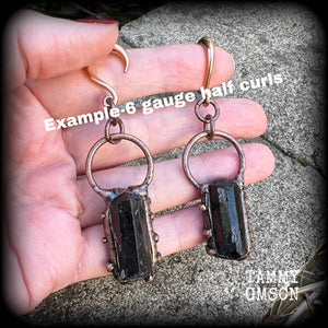 Featuring a pair of beautiful raw black tourmaline gemstones enclosed in rustic ornate copper plate detail, this pair of gorgeous gauged earrings weighs approx 16 grams a piece, and measure approx 8cms from tip to tip.

This pair have been made on 6 gauge (4mm) rose gold titanium coated surgical steel half curl hooks, suitable for stretched lobes.

