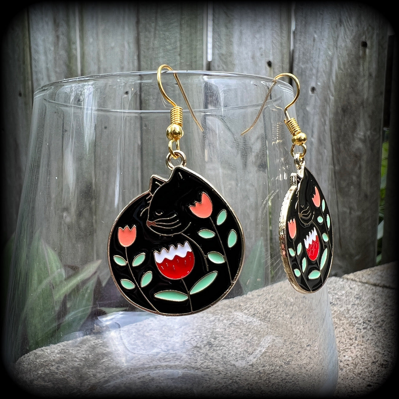 These quirky earrings and feature gorgeous folk art inspired black cat and tulip charms.
These earrings are nice and lightweight at only 4 grams, and measure just on 5cms from tip to tip.
This pair has been made with antique gold french hooks, to be worn in pierced ears.