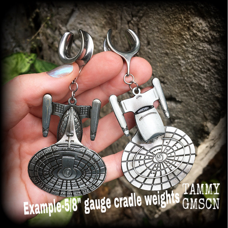 These awesome Star Trek USS Enterprise ear hangers feature a gorgeous big pewter Enterprise pendant, measuring just over 9cms from tip to tip, and weighing approx 37 grams each, nice and heavy.

This pair has been made on 5/8" gauge (16mm) surgical steel cradles, to be worn in stretched lobes.
