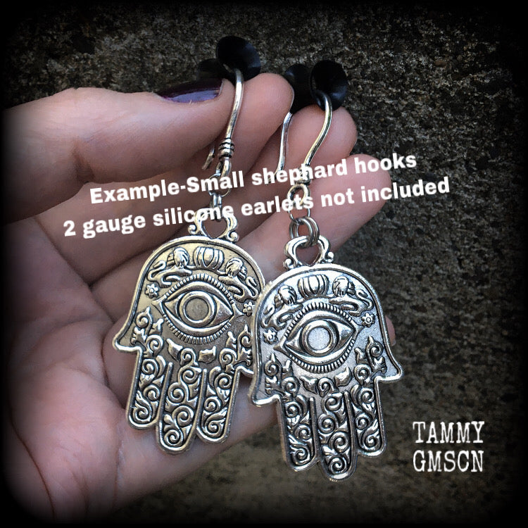 These antique silver Hamsa hand earrings weigh 10 grams each, measuring 7cms from tip to tip.
This pair has been made on small antique silver shephard hooks, suitable to be worn through stretched lobes with silicone earlets from 8 gauge (3mm).