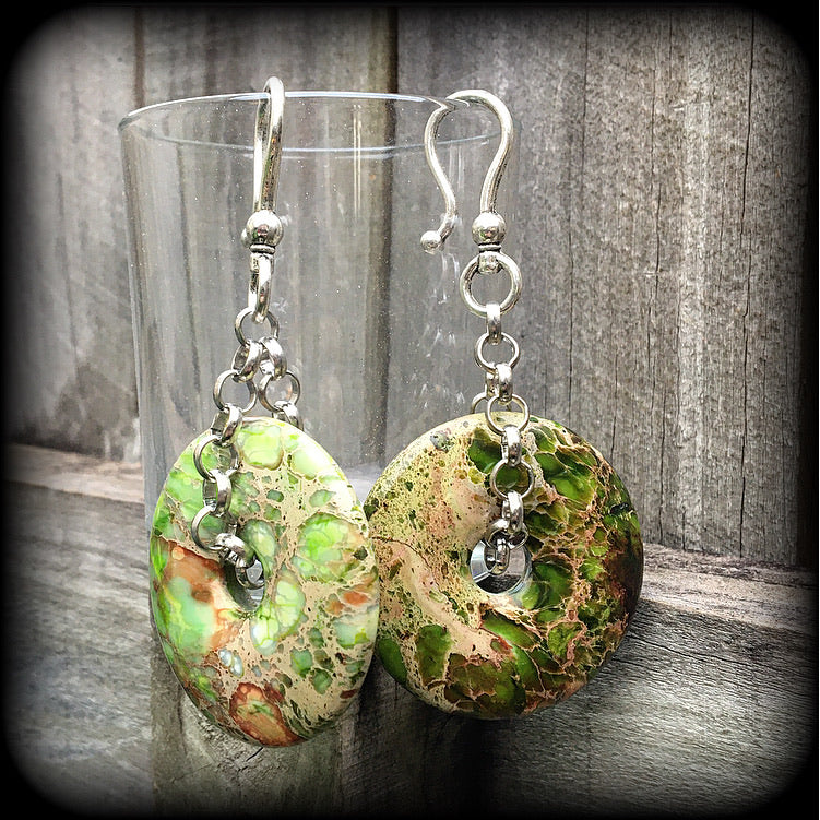 Featuring lime green ocean jasper donut gemstones, these earrings weigh in at approx 35 grams a piece, and hang just on 10cms from tip to tip.
This pair has been made with large antique silver shephard hooks, for stretched ears.