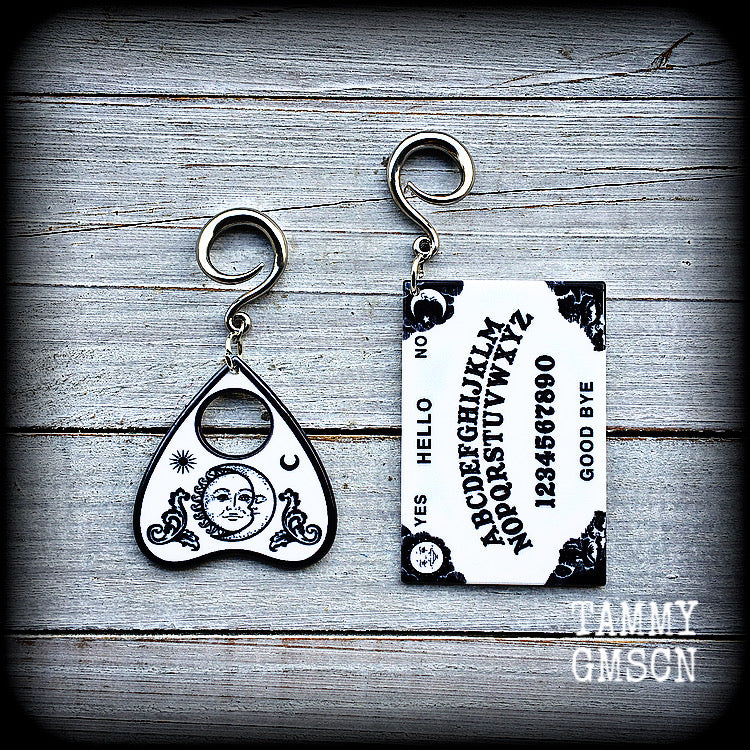 These spooky cute earrings feature black and white double sided acrylic ouija board and planchette charms, weighing approx 7 grams a piece, and measuring 7-9cms from tip to tip.

These have been made on 6 gauge (4mm) surgical steel full curl hooks, to be worn in stretched lobes.