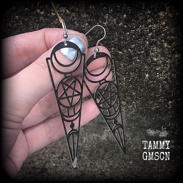These earrings feature gorgeous esoteric crescent moon and pentagram designs, are super light weight and nice and dangly, weighing only a gram or two each, and measuring just over 9cms from tip to tip.
This pair has been made with stainless steel french hooks, to be worn through pierced ears.
