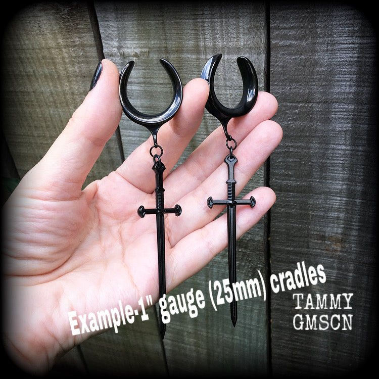 These gorgeous ear hangers feature a pitch black enamel sword pendant, measuring just on 12cms from tip to tip, and weighing approx 12 grams each.
This pair has been made on 1" (25mm) surgical steel cradle hooks, to be worn in stretched lobes.