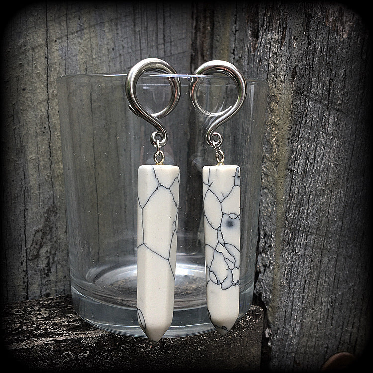 These earrings are made with beautiful white howlite stone points, measuring just on 8cms from tip to tip, and weighing approx 13grams each.
This pair has been made on 6 gauge (4mm) surgical steel full curl hooks, to be worn in stretched lobes.