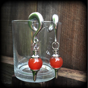 These gorgeous gauged earrings have been made with beautiful red jasper pendulums, measuring just under 9cms from tip to tip, and weighing approx 34 grams each.

This pair has been made on 00 gauge (10mm) surgical steel full curl hooks, to be worn in stretched lobes.