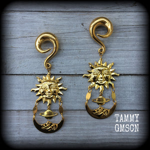 These earrings feature an antique crescent moon hanging below a ringed planet and gold sun.
Measuring 11 cms from tip to tip, these are nice and dangly, and weigh approx 32 grams each, made on 0 gauge (8mm) titanium coated surgical steel full curls.
