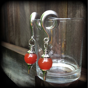 These gorgeous gauged earrings have been made with beautiful red jasper pendulums, measuring just under 9cms from tip to tip, and weighing approx 34 grams each.

This pair has been made on 00 gauge (10mm) surgical steel full curl hooks, to be worn in stretched lobes.