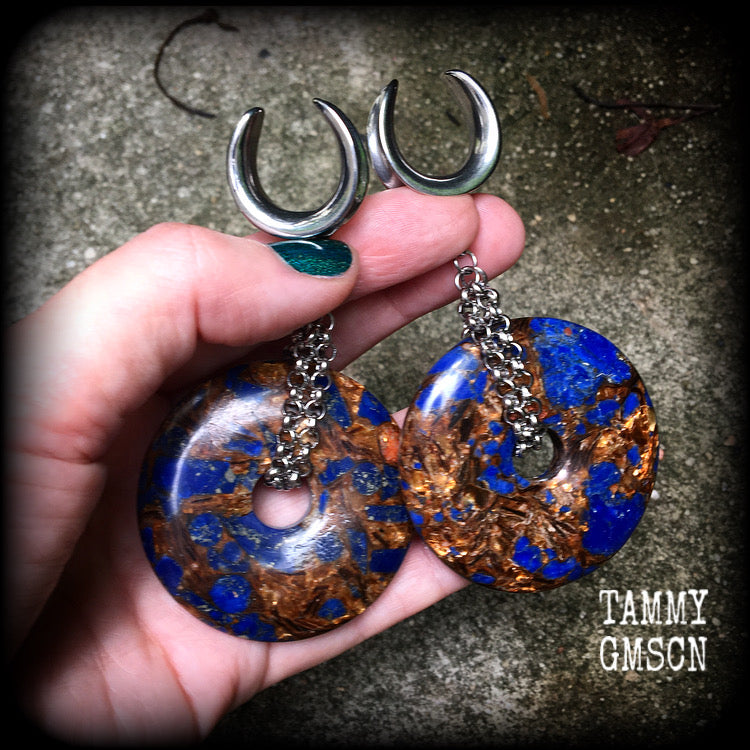 Featuring a pair of gorgeous dark blue lapis lazuli and bronzite donut gemstones cradles in stainless steel chain, this pair of ear hangers weigh approx 34 grams a piece, and measure just under 10cms from tip to tip.

This pair have been made on 7/8" (22mm) gauge surgical steel cradles, for stretched lobes.