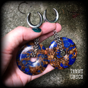 Featuring a pair of gorgeous dark blue lapis lazuli and bronzite donut gemstones cradles in stainless steel chain, this pair of ear hangers weigh approx 34 grams a piece, and measure just under 10cms from tip to tip.

This pair have been made on 7/8" (22mm) gauge surgical steel cradles, for stretched lobes.