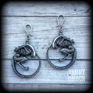 These awesome earrings feature a pair of large pewter Alien Queen Xenomorphs, measuring 9cms from tip to tip (nice and big), and weigh 38 grams each (these are HEAVY).

This pair have been made on small antique silver shephard hooks to be worn in stretched lobes with silicone earlets from 8 gauge (3mm).