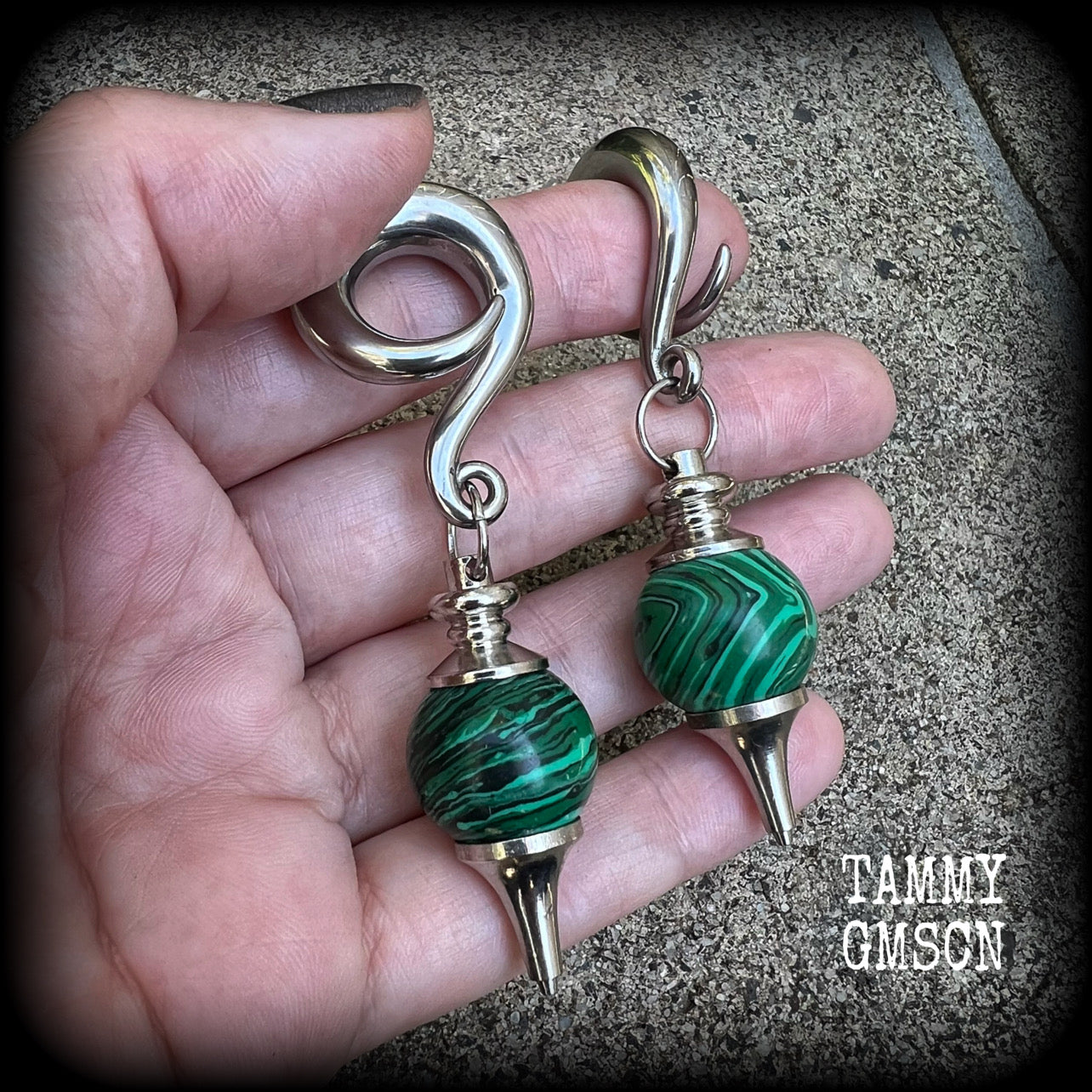 These gorgeous earrings feature deep green Malachite pendulums, weighing in at approx 26 grams each, and measure just on 8 cms from tip to tip, nice and dangly.

This pair has been made with 0 gauge (8mm) surgical steel full curl hooks, suitable for stretched lobes. 