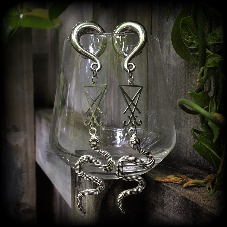These gorgeous 'Snake and Sigil' gauged earrings feature an antique silver snake (Lilith) hanging from a stainless steel Sigil of Lucifer charm.
These are nice and dangly at 12cms from tip to tip and weigh approx 20 grams each, not too heavy.
This pair have been made on 0 gauge (8mm) surgical steel full curl hooks, suitable for stretched lobes.
