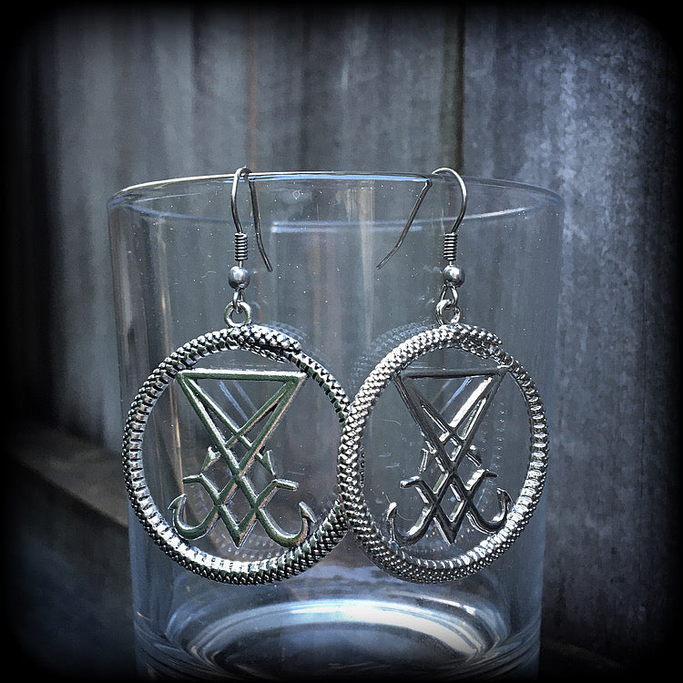 These gorgeous antique silver 'Ouroboros and Sigil of Lucifer' earrings are light weight at approx 5 grams a piece, and nice and dangly, measuring just over 5cms from tip to tip.
This pair has been made with stainless steel french hooks, suitable for pierced ears.
